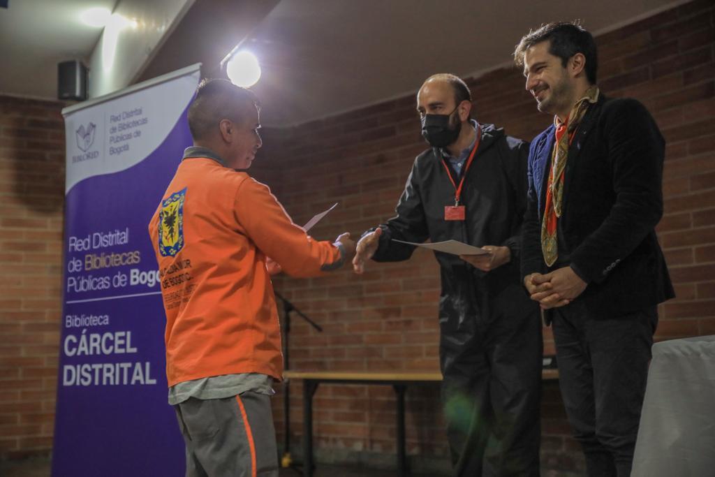 Entrega del reconocimiento a uno de los 25 hombres privados de la libertad que culminaron los módulos de la Escuela Hombres Al Cuidado en la Cárcel Distrital.